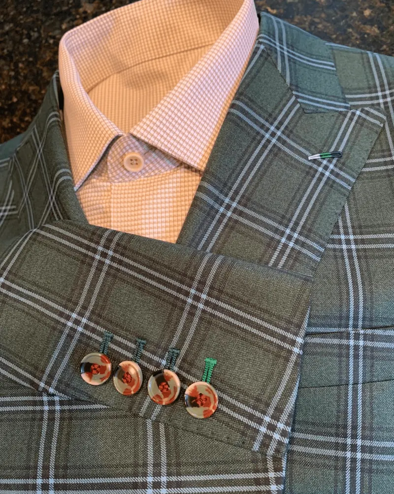 Custom green plaid jacket with contrast buttonholes over a pink check dress shirt