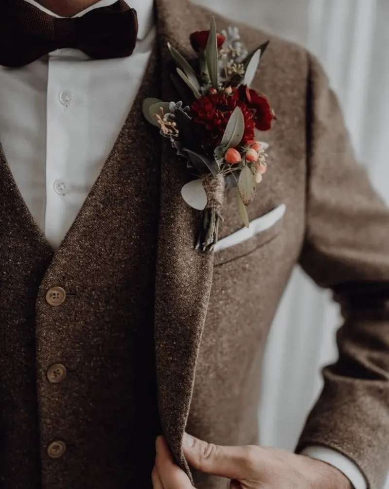 Brown tweed custom suit and vest with a bow tie and boutonniere